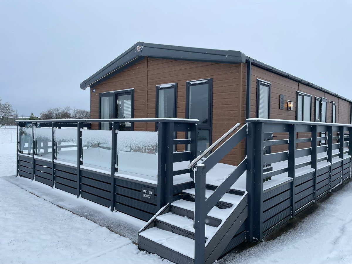 Oak Tree Lodge with snow-covered decking and steps at Skiddaw View